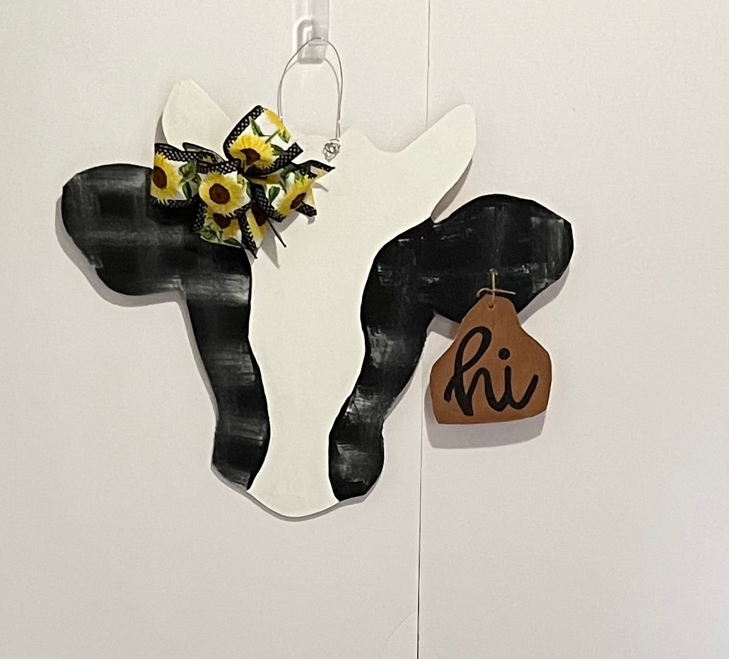 Hand-painted farmhouse cow door hanger saying Hi, finished with a bow and beads for a year-round front door