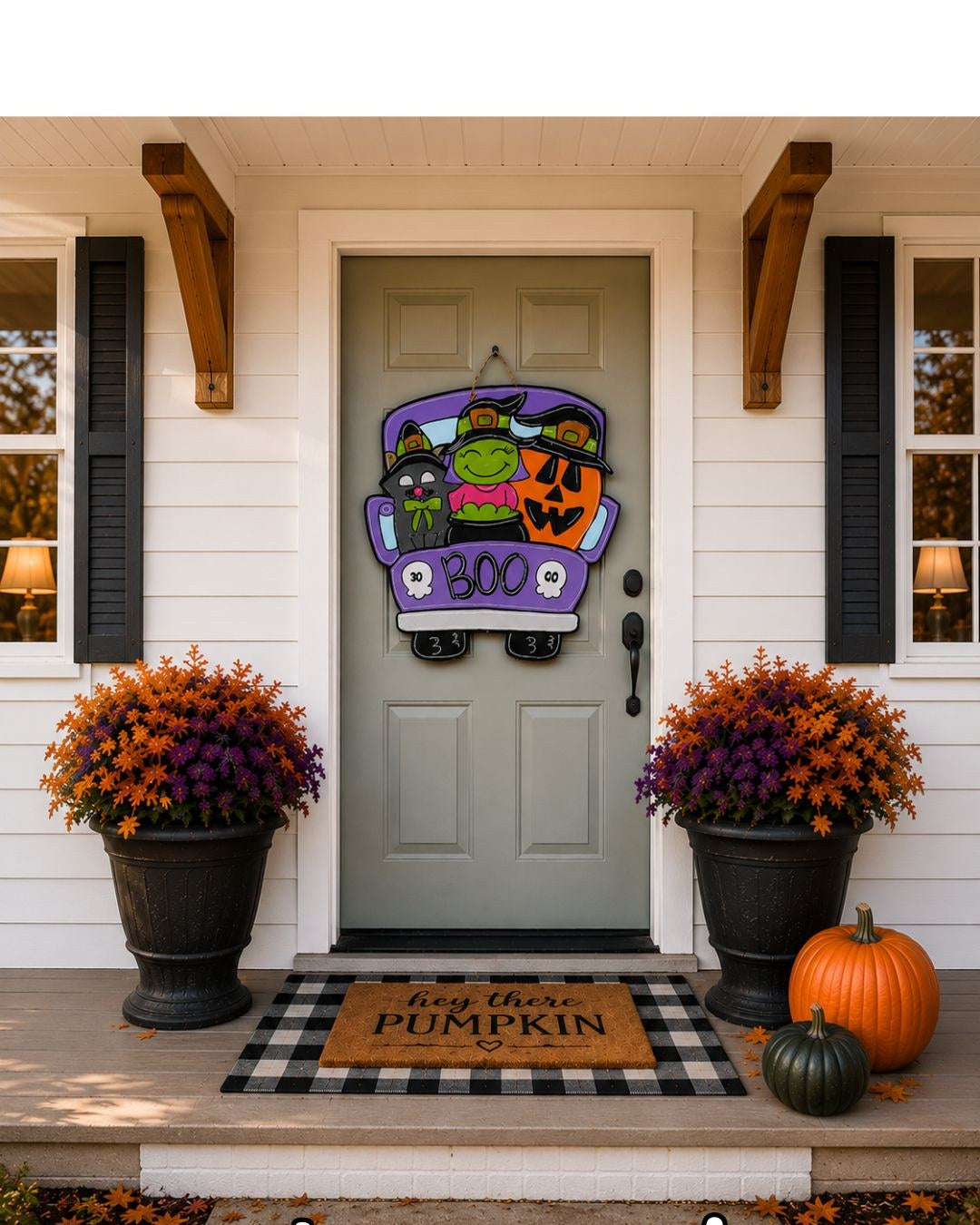 Hand-painted Boo Crew truck door hanger — witch, black cat and jack-o'-lantern in a purple truck — styled on a front porch with mums and pumpkins for Halloween