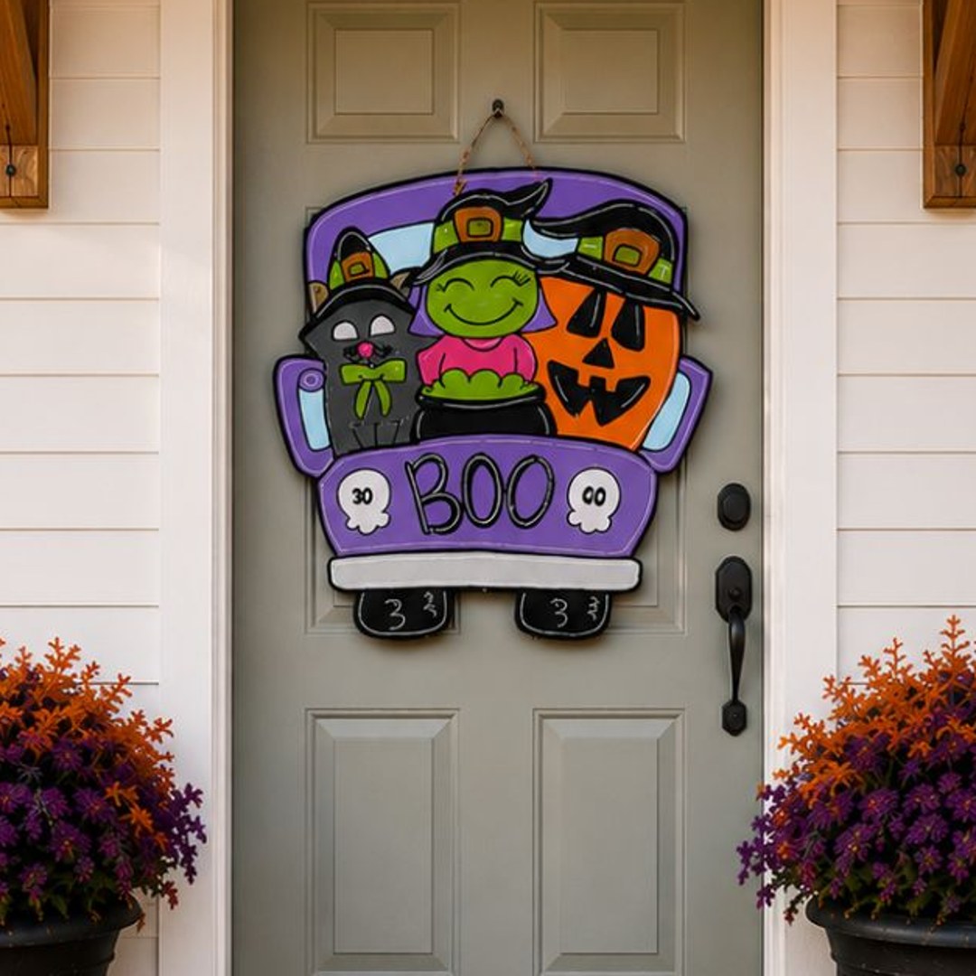 Close-up of the hand-painted Boo Crew truck door hanger with a witch, black cat and jack-o'-lantern for a Halloween front door